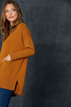Load image into Gallery viewer, The Mellow Knit in Amber, by eb&amp;ive, is the perfect piece for dressing up or down.  This gorgeous block knit comes in several colours &amp; sizes.  It has a v-neckline, front pockets, drop shoulders, side vents and is slightly longer at the back.  Whether you are partnering it with joggers, leggings or your favourite jeans, you can&#39;t go wrong with this versatile piece.  Made from 50% viscose, 29% elastane, 21% polyamide.
